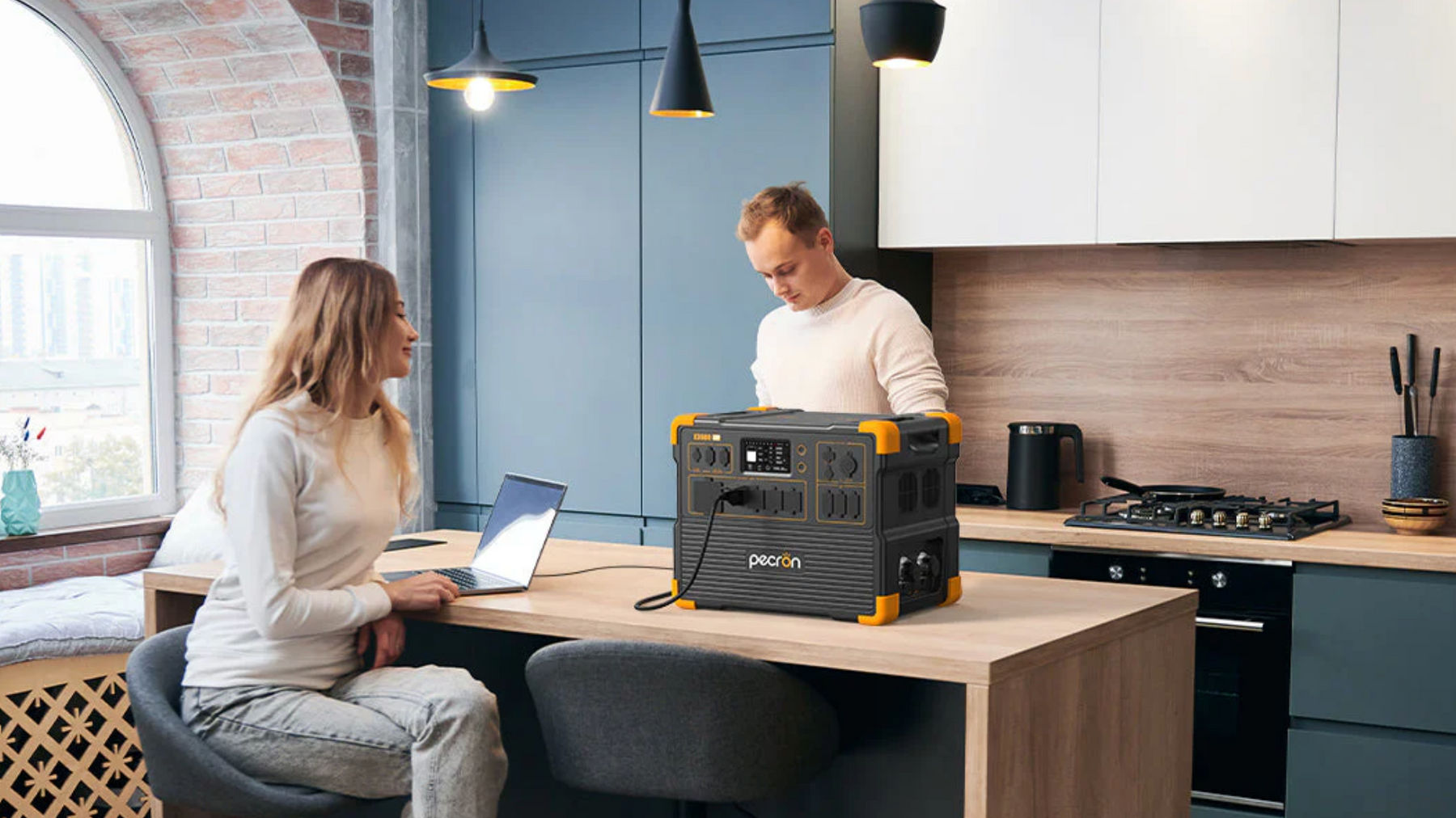 PECRON E3600LFP Solar Generator Kit being used in a modern kitchen by a couple to power a laptop www.mygeneratorplus.com