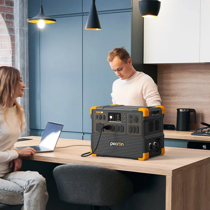 PECRON E3600LFP Solar Generator Kit being used in a modern kitchen by a couple to power a laptop www.mygeneratorplus.com