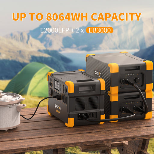 PECRON E2000LFP Expandable Solar Generator with solar panels with camping setup on a wooden table with mountains in the background with  LiFePO4 battery mygeneratorplus.com