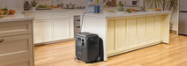 BLUETTI Elite 320 Portable Power Station with 1,800 W Output | 3,200 Wh , LCD display and multiple ports on a wooden floor and a white kitchen in the background www.mygeneratorplus.com 