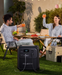 BLUETTI Elite 320 Portable Power Station with 1,800 W Output | 3,200 Wh , LCD display and multiple ports on a grass with a couple making a toast at a picnic background www.mygeneratorplus.com 